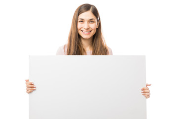 Naklejka premium Happy Woman Holding Blank Billboard Over White Background