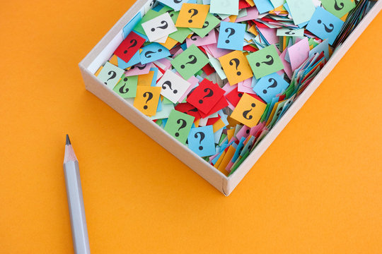 Pencil And Question Marks In A Paper Box