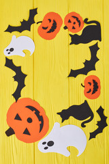 Halloween background with paper decorations. Halloween paper silhouettes with blank copy space on yellow background.