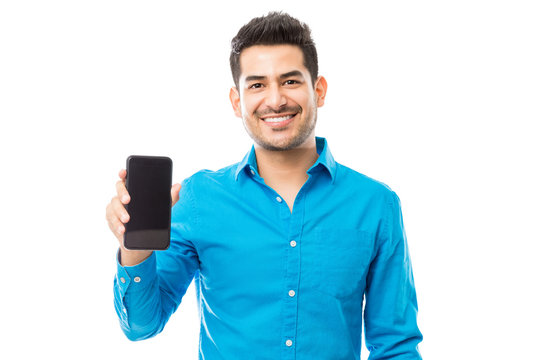 Attractive Male Smiling While Holding Smartphone