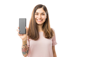 Pretty Female Smiling And Presenting Her New Mobile Phone