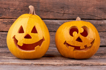 Halloween pumpkins on wooden background. Pumpkins for traditional autumn holiday. Funny pumpkin carving.
