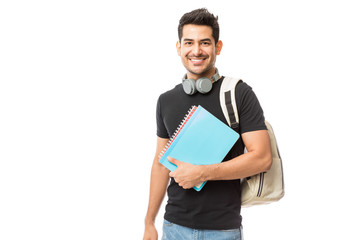 Smiling Young College Student With Books And Backpack - obrazy, fototapety, plakaty