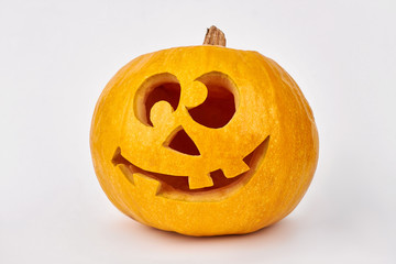 Carved Halloween pumpkin. Funny Jack-O-Lantern Halloween pumpkin isolated on white background. Easy pumpkin carving ideas.