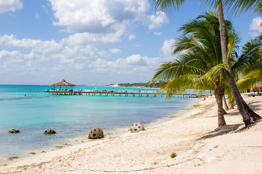 Amazing exotic landscape of the Caribbean sea beach: palms, pier and attractive turquoise water. Bounty style photo. High resolution