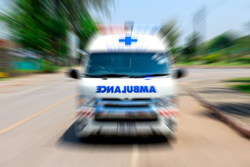 Out of focus of Ambulance speeding to accident, Emergency ambulance travels through city street zoom effect applied for dramatic effect, Ambulance first aid abstract motion blur shot. © Amnat