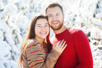 Couple in love in winter forest.