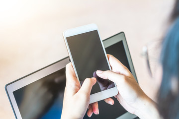 Man's hands holding a credit card and using laptop for online shopping.