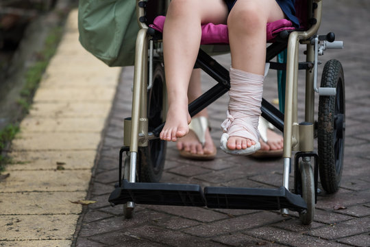 Leg broken child on wheelchair walked in park