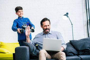 Busy father not paying enough attention to his son