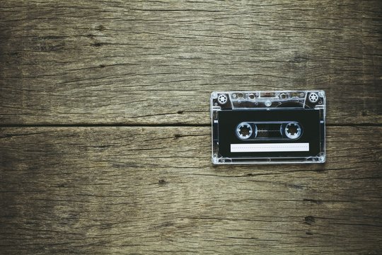 vintage audio cassette tapes on wooden background. - vintage backdrop style.