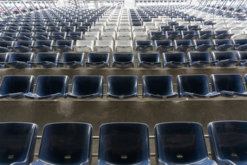 Obraz premium empty Rows of stadium grandstand seats or stadium seats, plastic blue and white seats on grand stadium pattern.