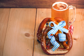  Pretzel with glass of beer on wood table for oktoberfest,have space for copy.