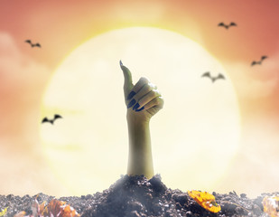Zombie hand rising out of grave