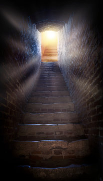 Light at end of tunnel in castle . Steps leading up to the sun.  Way to God .  bright light from heaven .  Religious background  .