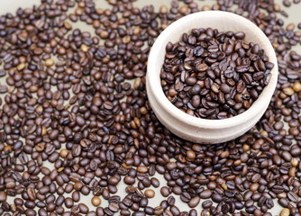 Coffee beans in a wooden cup. 