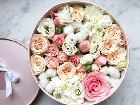 Flowers in a box roses and colorful macaroons macaroni marshmallow cotton