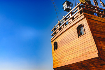 Stern of old galley docked in port to navigate the ocean in the discovery of America.