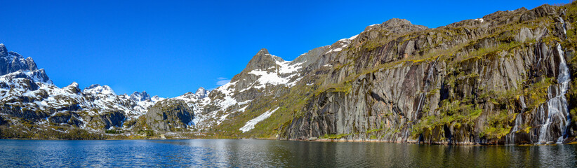 Fototapeta na wymiar Panoramic fjord with a waterfall in the Lofoten, Norway.