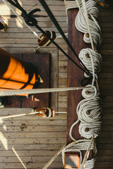 Ropes to hold the sails of an old sailboat rolled.