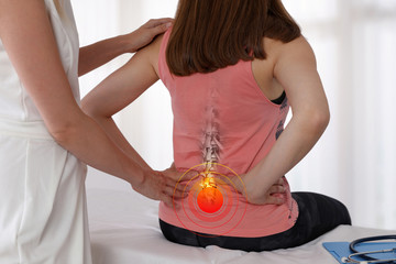 Woman suffering from low back during medical exam. Chiropractic, osteopathy, Physiotherapy....