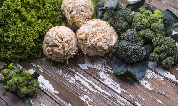 Green dill, parsley, celery root, broccoli - natural organic freshly picked vegetables for cooking healthy eating isolated on a wooden background.