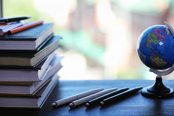 A stack of textbooks on the windowsill