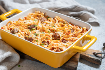 Linguine baked with meatballs, tomato sauce and cheese