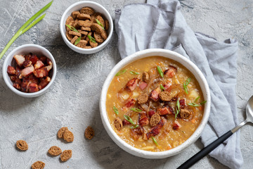 Lentil pea soup garnish with bacon and croutons