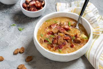 Lentil pea soup garnish with bacon and croutons