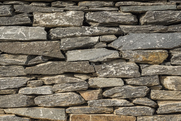 Beautiful stone wall, Stone wall with flat Stones, Close up of a stone wall
