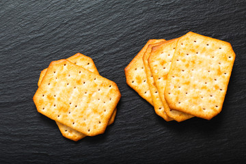 Food appetizer salted Crackers on black slate board with copy space
