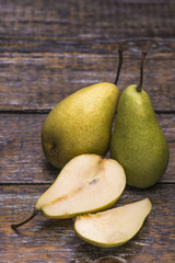 Home grown organic pears for fresh juice on a wooden background with copy space.