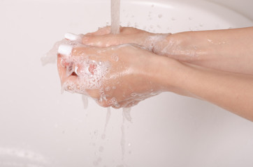 Fototapeta premium Soapy hands water faucet bathroom disinfection care