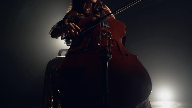 The cellist performs on stage.