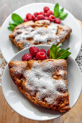 Apple pie with fresh raspberries and mint on a wooden background. Selective focus, romantic breakfast, healthy eating.