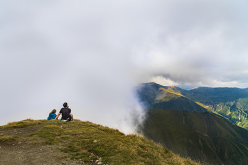 Young couple traveler standing and looking at beautiful landscape on top of mountain