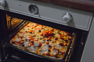 horizontal image of homemade pizzas while baking in the oven