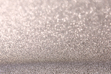 The Glittering glitter background with a bokeh.