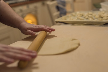 Fototapeta na wymiar horizontal image of woman's hands stretching and working pizza dough