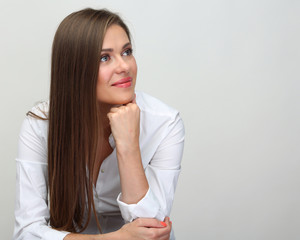 Happy woman wearing white shirt looking to side.