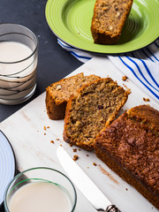 Whole grain banana bread for breakfast on white wooden board