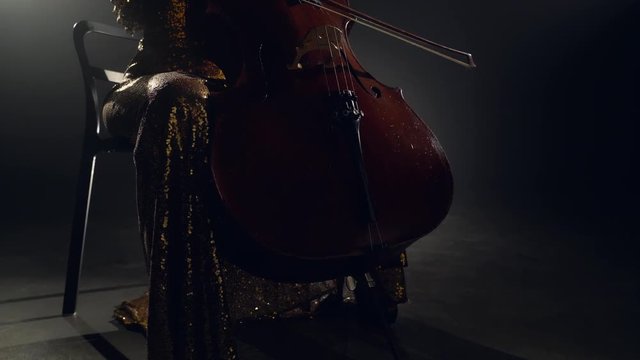 The cellist performs on stage.
