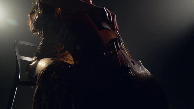 The cellist performs on stage.