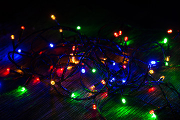 Fototapeta na wymiar Lights of a New Year garland on a black background