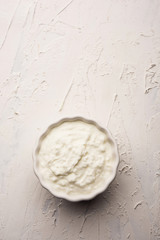 Plain curd or yogurt or Dahi in Hindi, served in a bowl over moody background. Selective focus