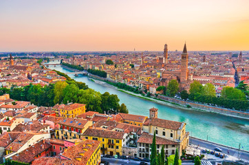 Fototapeta na wymiar View of the historic city center along Adige river at sunset in Verona, Italy.