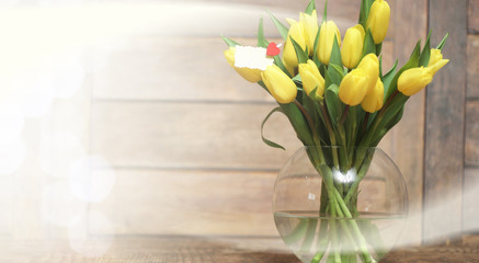 bouquet of yellow tulips in a vase on the floor