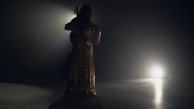 The cellist performs on stage.