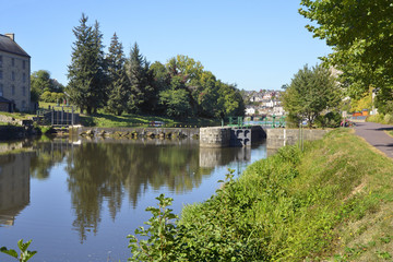 Fototapeta na wymiar River Oust, part of canal Nantes at Brest, and sluice at Josselin, a commune in the Morbihan department in Brittany in north-western France